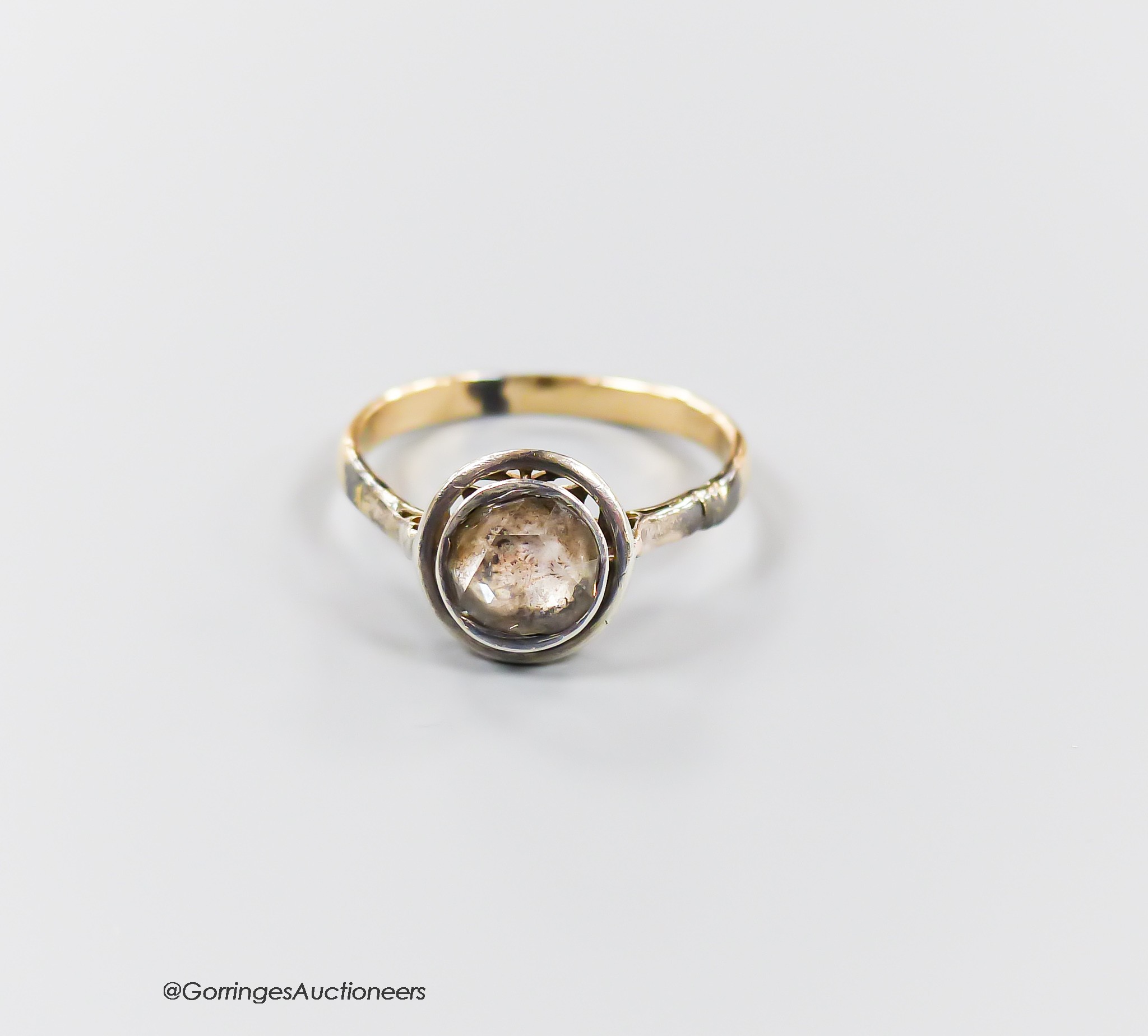 An antique continental yellow metal and solitaire rose cut diamond set ring, size M/N, gross weight 2.3 grams